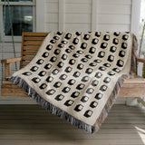 Cube Cotton Blend Blanket Throw in White, draped over a chair