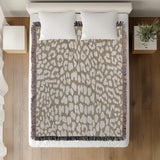 Delo Animal Print Cotton Blend Blanket Throw in Beige, on a bed