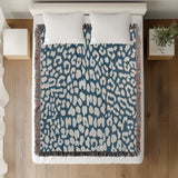 Delo Animal Print Cotton Blend Blanket Throw in Blue, on a bed