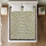 Delo Animal Print Cotton Blend Blanket Throw in Chartreuse, on a bed