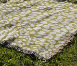 Delo Animal Print Cotton Blend Blanket Throw in Chartreuse, draped over a chair