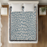 Delo Animal Print Cotton Blend Blanket Throw in Light Blue, on a bed
