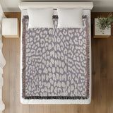 Delo Animal Print Cotton Blend Blanket Throw in Periwinkle, on a bed