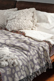 Delo Animal Print Cotton Blend Blanket Throw in Periwinkle, draped over a chair