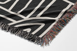 Diof Abstract Print Cotton Throw Blanket in Black and Beige, side view