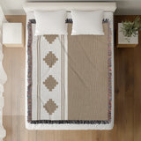 Ector Southwestern Cotton Blend Blanket Throw in Beige and Off-White, on a bed