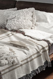 Ector Southwestern Cotton Blend Blanket Throw in Beige and Off-White, draped over a chair