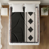 Ector Southwestern Cotton Blend Blanket Throw in Black and Off-White, on a bed