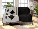 Ector Southwestern Cotton Blend Blanket Throw in Black and Off-White, draped over a chair