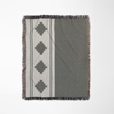 Ector Southwestern Cotton Blend Blanket Throw in Gray and Off-White, on a bed