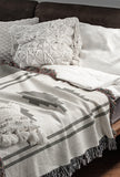 Ector Southwestern Cotton Blend Blanket Throw in Gray and Off-White, draped over a chair