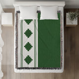 Ector Southwestern Cotton Blend Blanket Throw in Green and Off-White, on a bed