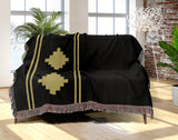 Ector Southwestern Cotton Blend Blanket Throw in Black and Dull Gold, draped over a chair