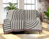 Eko Cotton Blend Blanket Throw in Black, draped over a chair