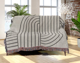 Eko Cotton Blend Blanket Throw in Gray, draped over a chair