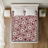 Dandelion Floral Cotton Throw Blanket in Red, on a bed