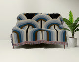 Farni Cotton Blend Blanket Throw in Blue, draped over a chair