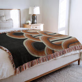 Farni Cotton Blend Blanket Throw in Burnt Orange, on a bed