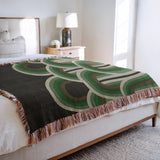 Farni Cotton Blend Blanket Throw in Green, on a bed