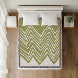Addai Abstract Triangle Pattern Blanket Throw in Chartreuse, on a bed