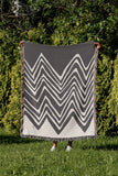 Addai Abstract Triangle Pattern Blanket Throw in Gray, outdoors