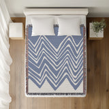 Addai Abstract Triangle Pattern Blanket Throw in Light Blue, on a bed