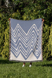 Addai Abstract Triangle Pattern Blanket Throw in Light Blue, outdoors