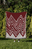 Addai Abstract Triangle Pattern Blanket Throw in Red, outdoors