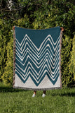 Addai Abstract Triangle Pattern Blanket Throw in Teal, outdoors