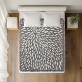 Addy Floral Cotton Throw Blanket in Gray, on a bed