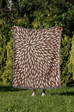 Addy Floral Cotton Throw Blanket in Rust Brown, outdoors