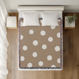 Akon Hand Woven Throw Blanket in Beige, on a bed