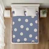 Akon Hand Woven Throw Blanket in Light Blue, on a bed