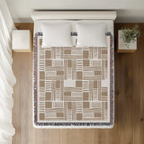 Anala Abstract Cotton Throw Blanket in Beige, on a bed