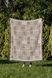 Anala Abstract Cotton Throw Blanket in Beige, outdoors