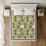 Anala Abstract Cotton Throw Blanket in Chartreuse, on a bed