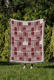 Anala Abstract Cotton Throw Blanket in Red, outdoors