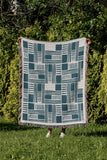 Anala Abstract Cotton Throw Blanket in Teal, outdoors