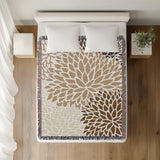 Arlo Floral Burst Cotton Throw Blanket in Beige, on a bed