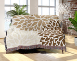 Arlo Floral Burst Cotton Throw Blanket in Beige, draped over a sofa