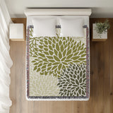 Arlo Floral Burst Cotton Throw Blanket in Chartreuse, on a bed