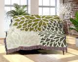 Arlo Floral Burst Cotton Throw Blanket in Chartreuse, draped over a sofa