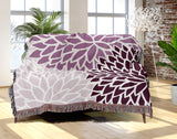 Arlo Floral Burst Cotton Throw Blanket in Purple, draped over a sofa