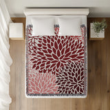 Arlo Floral Burst Cotton Throw Blanket in Red, on a bed