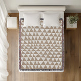 Asaba Abstract Cotton Throw Blanket in Beige, on a bed