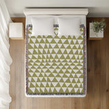 Asaba Abstract Cotton Throw Blanket in Chartreuse, on a bed
