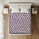 Asaba Abstract Cotton Throw Blanket in Purple, on a bed