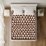 Asaba Abstract Cotton Throw Blanket in Rust Brown, on a bed