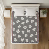 Atia Cheetah Print Cotton Throw Blanket in Gray and Blue, on a bed