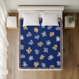 Atia Cheetah Print Cotton Throw Blanket in Navy Blue and Beige, on a bed